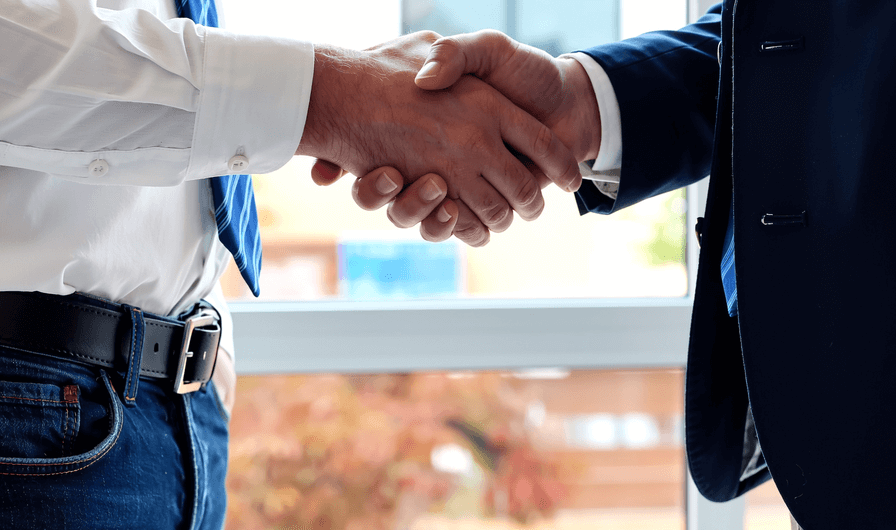 People shaking hands in business setting